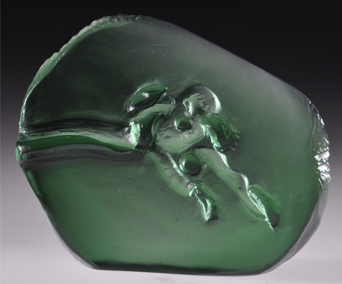 Green glass piece with an intricate design