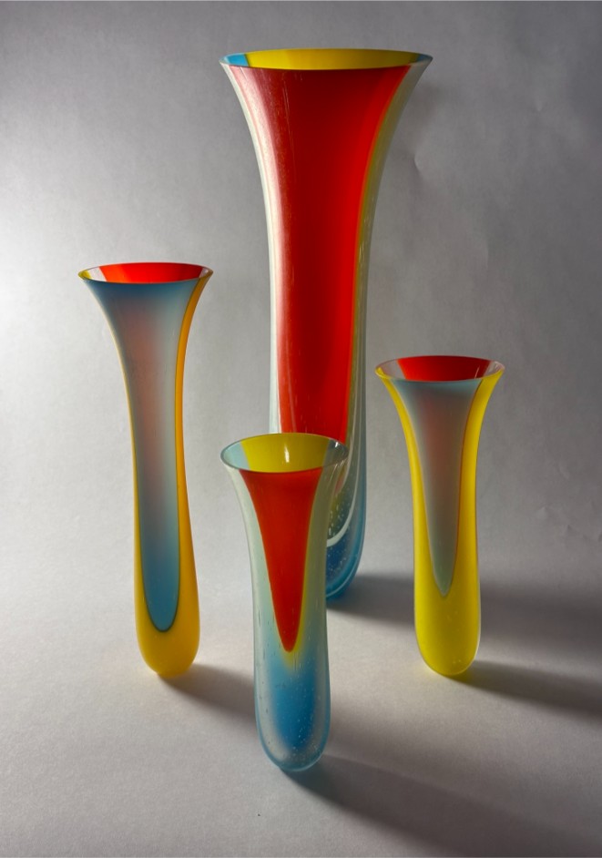 Four different sized colorful glass vases